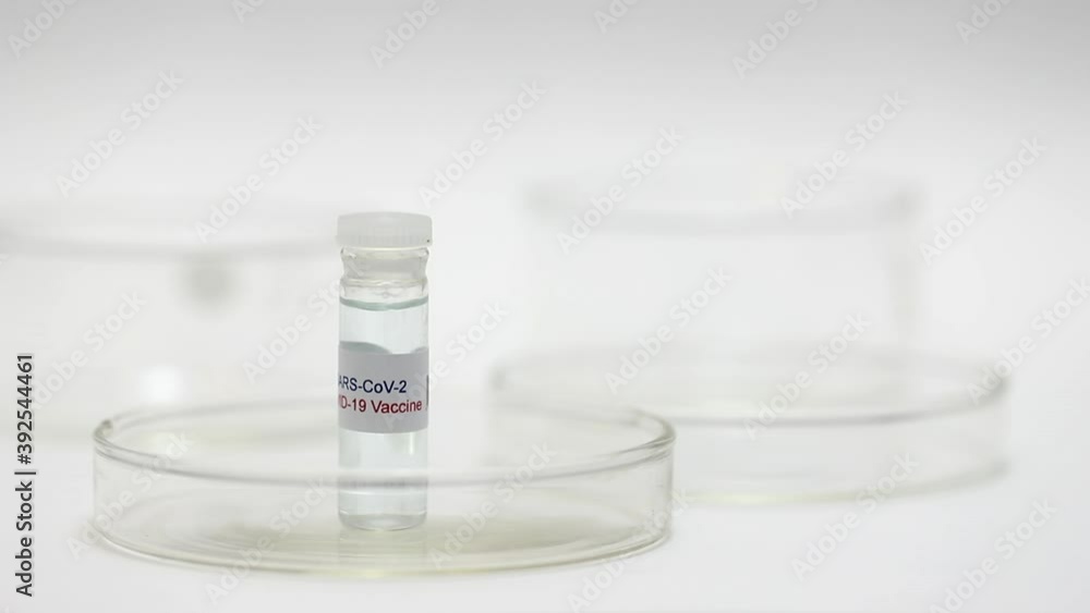 Covid-19 Vaccine Bottle with syringe being put onto a glass tray
Covid-19 Vaccine Bottle with syringe being put onto a glass tray
