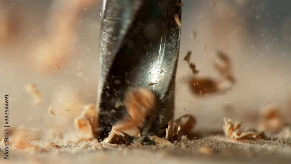 Super slow motion of detail of a drill bit drilling into wood. Filmed on high speed cinema camera, 1000 fps. Super slow motion of detail of a drill bit drilling into wood. Filmed on high speed cinema camera, 1000 fps.
