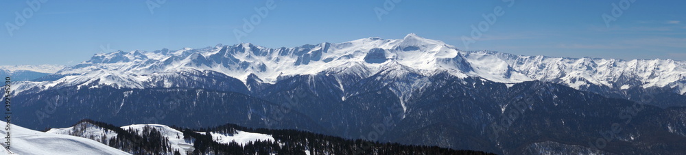 Scenes from the life of a ski resort, beautiful views of winter snow-capped mountains and blue skies.