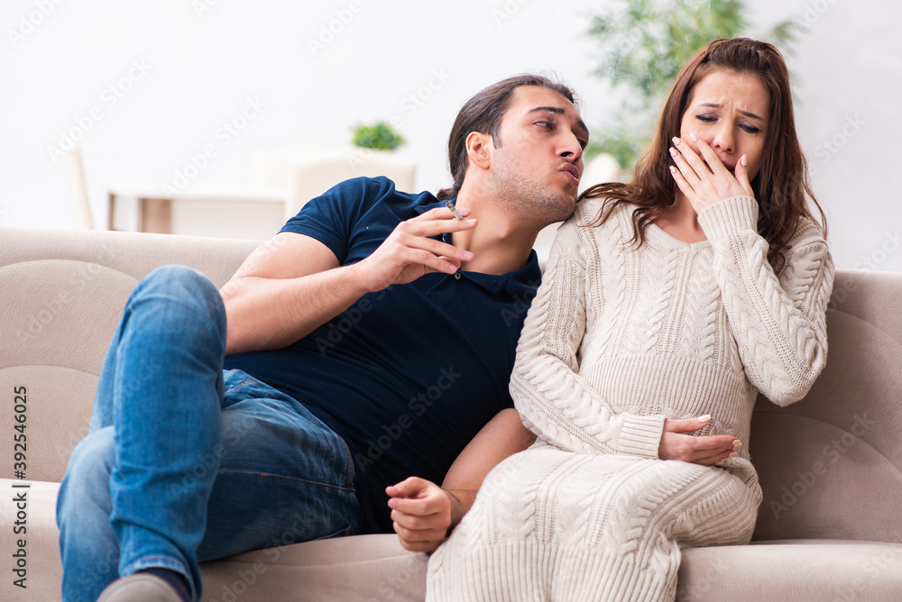 Man and pregnant woman in antismoking concept
