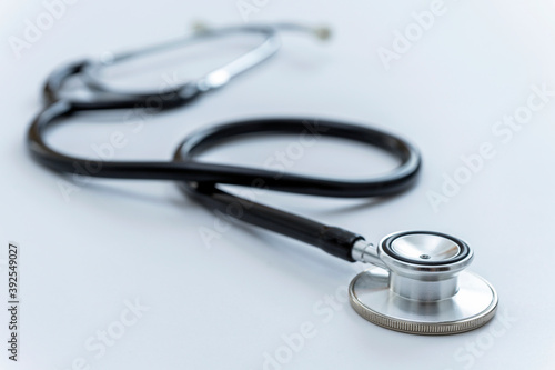 CLOSE UP OF A STETHOSCOPE ON THE DOCTOR'S DESK. HEALTH AND MEDICAL INSURANCE CONCEPT.