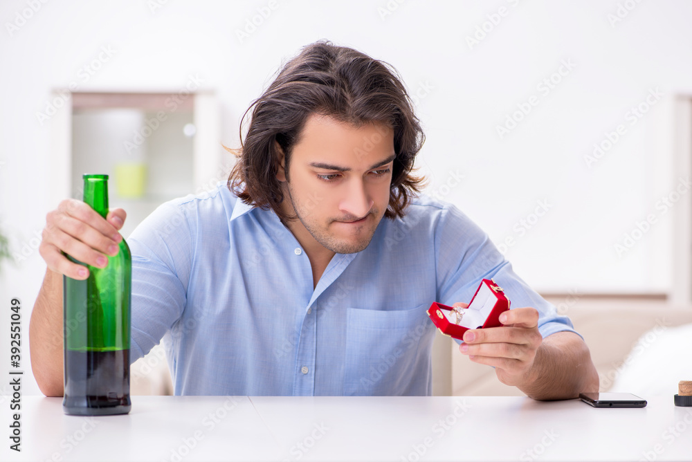Young male alcoholic in unrequited love concept Young male alcoholic in unrequited love concept