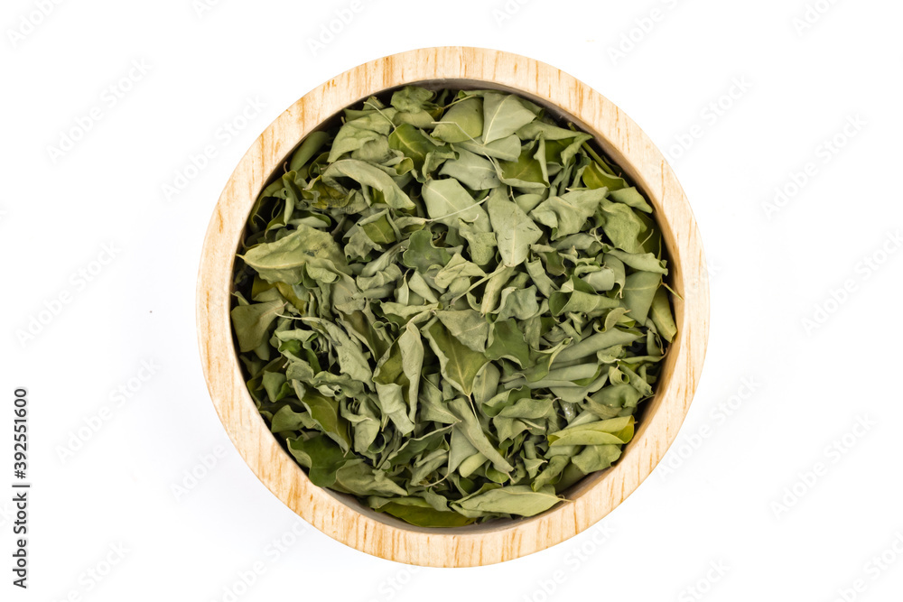 Moringa tea for healthy on wooden bowl isolated on white background. Moringa tea for healthy on wooden bowl isolated on white background.
