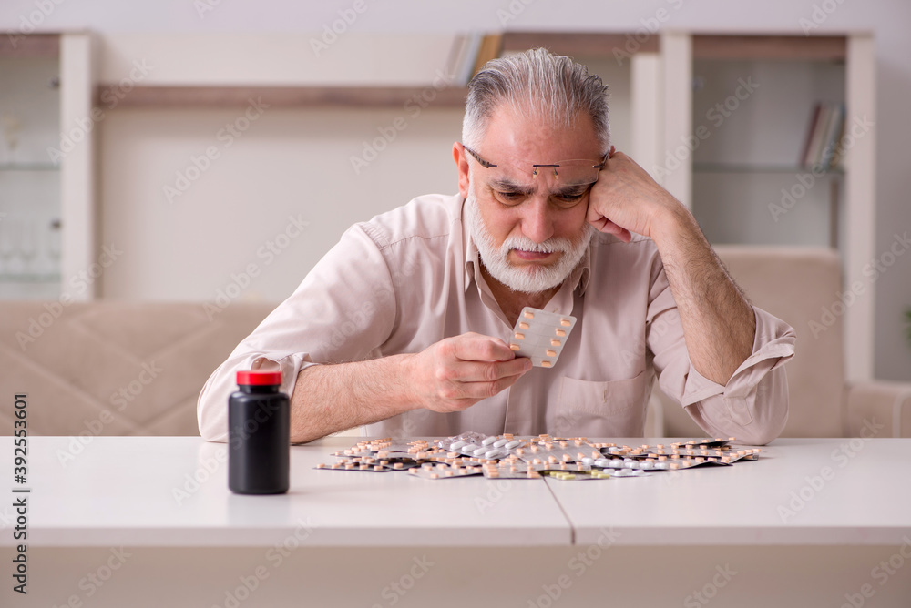 Old sick man suffering at home Old sick man suffering at home