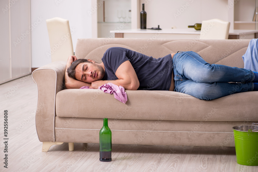 Young unemployed man drinking alcohol at home Young unemployed man drinking alcohol at home