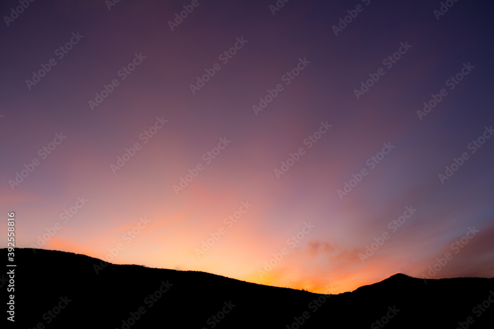 Sunset Behind Mountain Silhouette
