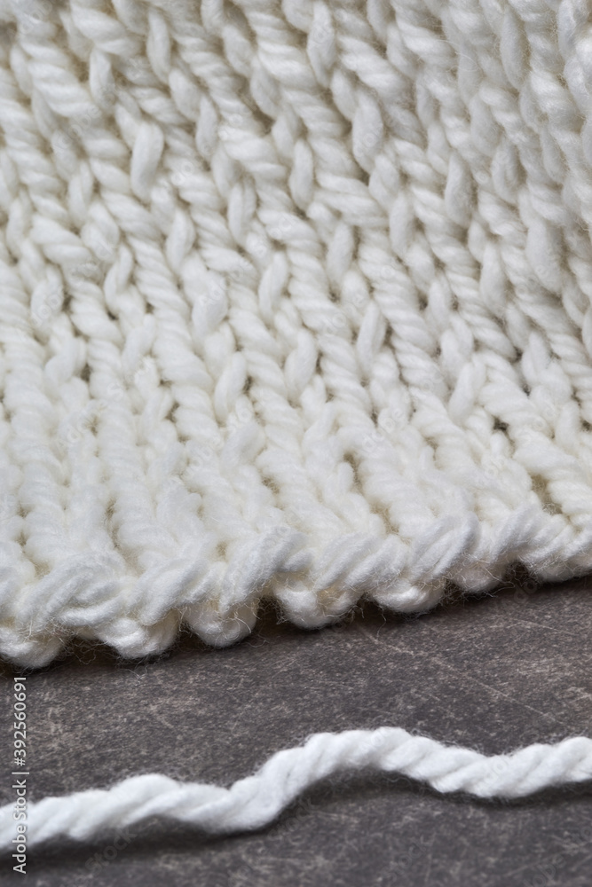white wool knitted lies on gray background white wool knitted lies on gray background