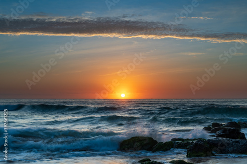 Beautiful sunrise with high cloud at the seaside