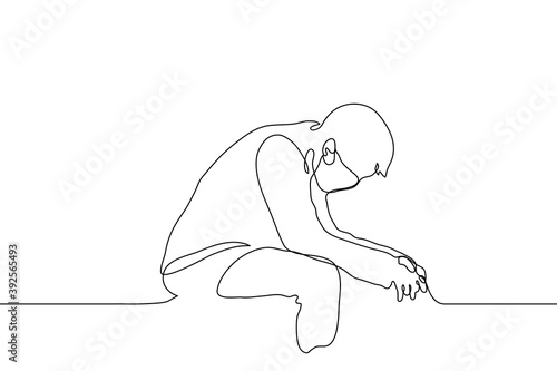 man sits in mask with his elbows on his knees,  back is bent, head is down, hands are relaxed. one line drawing a person is tired, tense, empty, frustrated or depressed