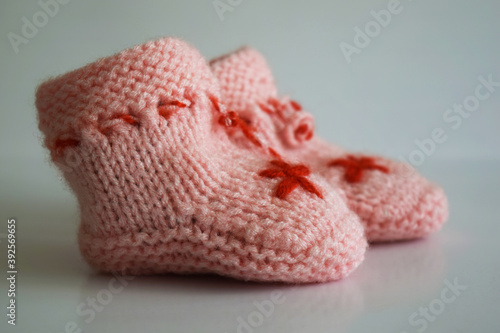 Pink baby socks, knitwear, handmade, on the white background, newborn, child theme