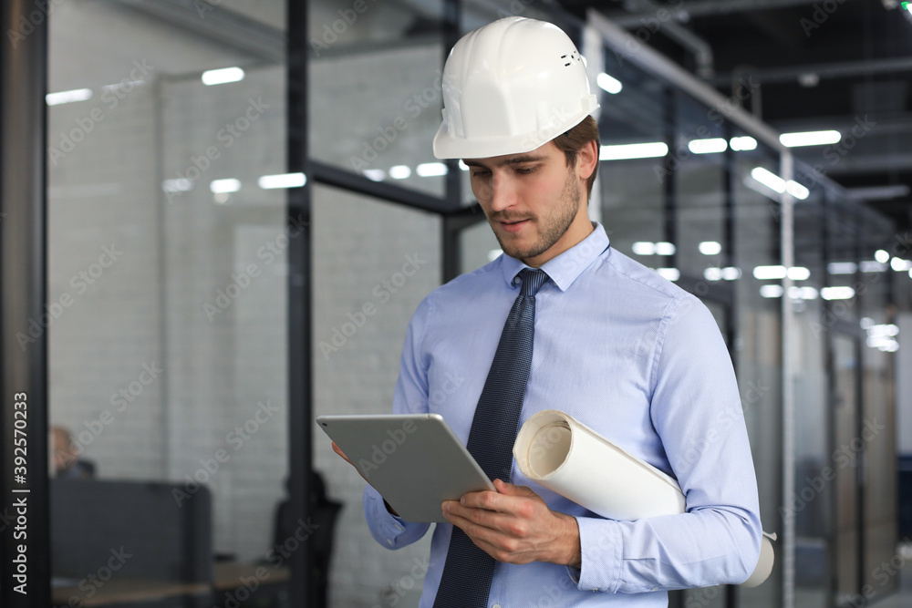 Shot of a engineer using a digital tablet on a construction site. Shot of a engineer using a digital tablet on a construction site.