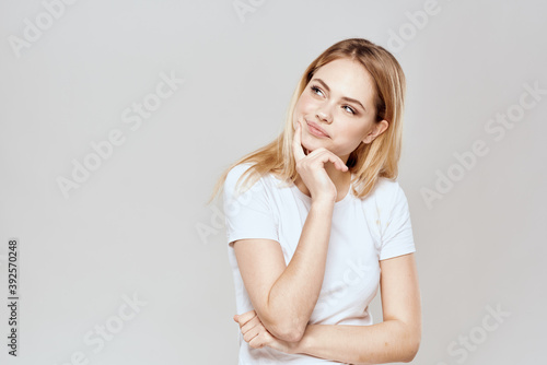 Cute blonde white t-shirt gesture with hands lifestyle light background