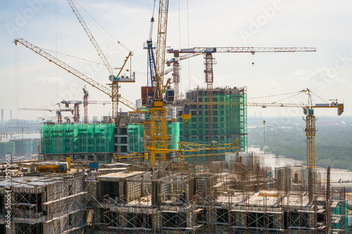 Many Tower crane on top of a big building in construction work