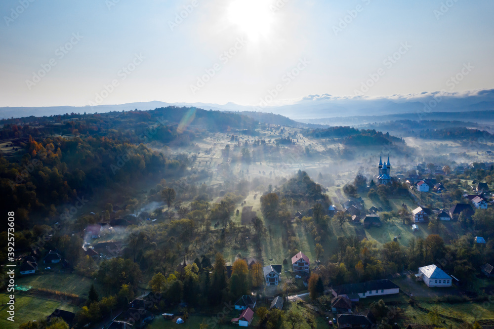 Aerial view over small rural village of Breb in magic sunrise.