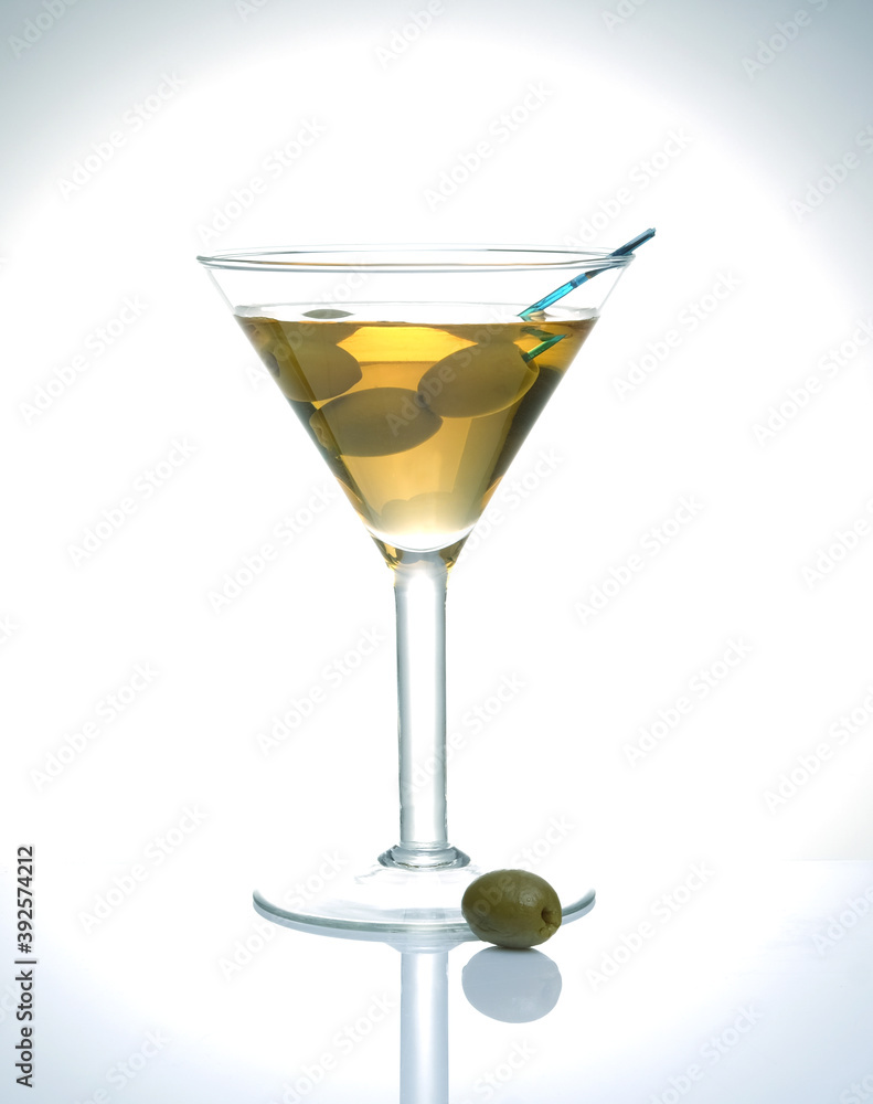 glass with a drink and olives glass with a drink and olives