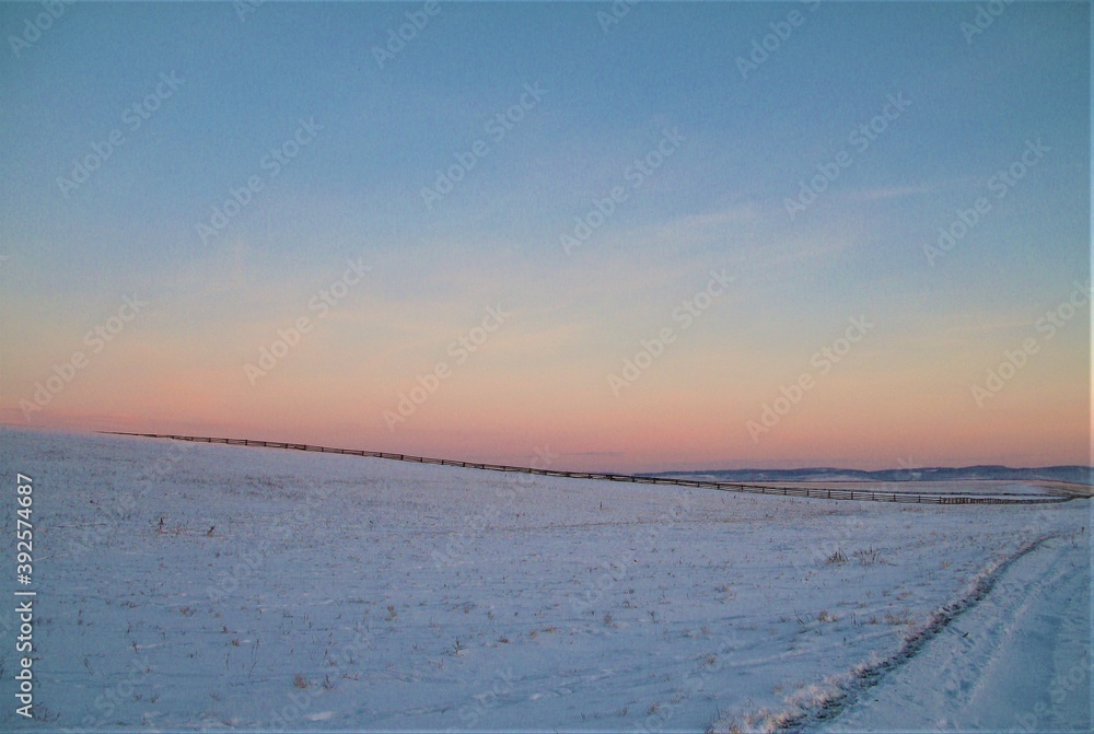 snowfield. snow glade at sunset.winter background