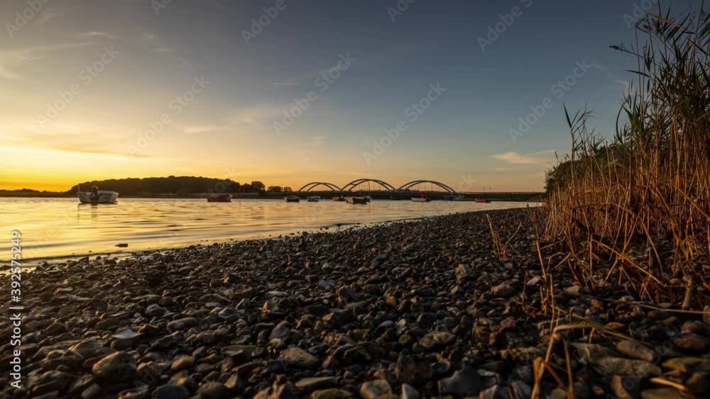 Sunset at Munkholm Bridge in Denmark with small boats in the fjord. A slider was used for the movement Sunset at Munkholm Bridge in Denmark with small boats in the fjord. A slider was used for the movement