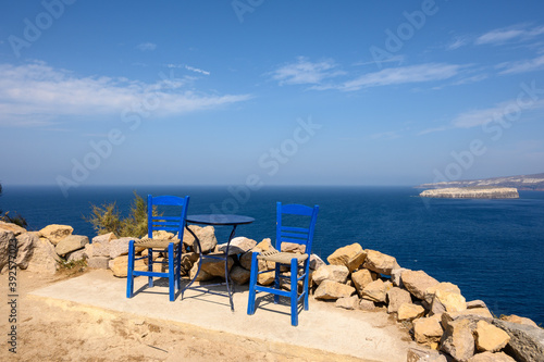 Table and chairs overlooking the caldera in Santorini island. Cyclades, Greece © vivoo