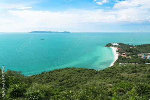Aerial view from Thailand's Koh Larn overlooking the community and the beaches with the sea during the day time amide the blue sky.