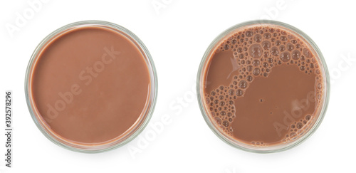 Chocolate milk puddle in glass isolated on white background.
