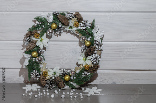 Christmas wreath with snowflakes on a gray and white background.