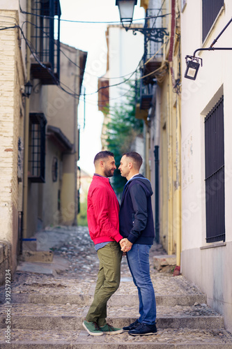 Gay couple in a romantic moment in the street.