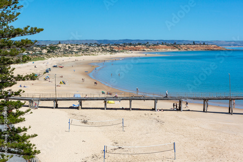 The iconic port noarlunga jetty with people on the beach on a hot day in South Australia on November 2 2020