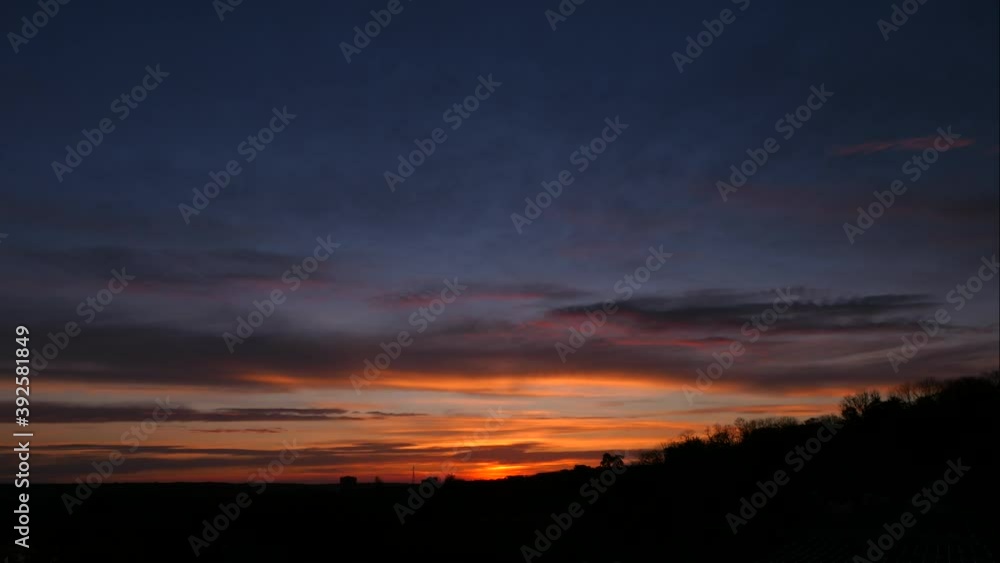 Time lapse of amazing sunrise in rural scene. Silhouette of vegetation on hill with dramatic sky and rays of sun on the horizon. Time lapse of amazing sunrise in rural scene. Silhouette of vegetation on hill with dramatic sky and rays of sun on the horizon.