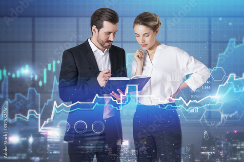 Man and woman in office, digital graphs