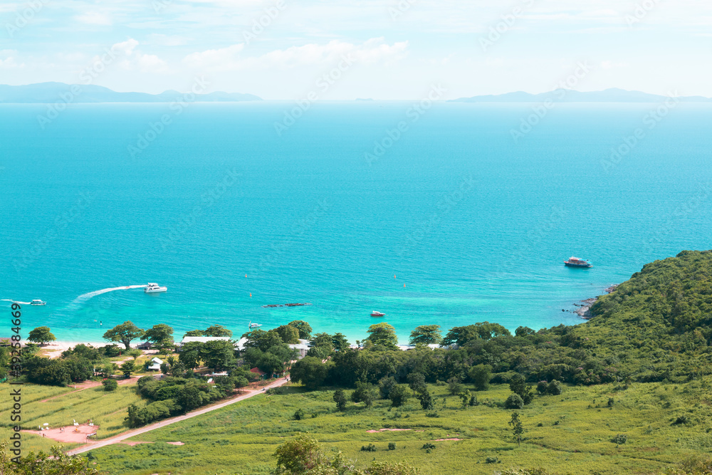 Aerial view from Koh Larn of Thailand overlooks the sea during day time amongst the blue sky.