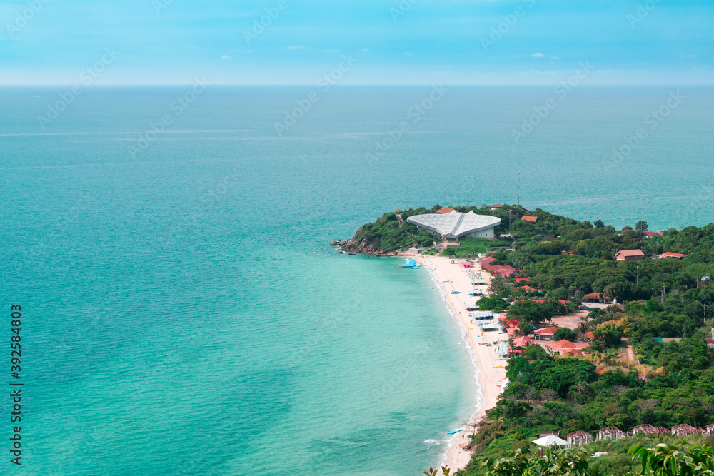 Aerial view from Thailand's Koh Larn overlooking the community and the beaches with the sea during the day time amide the blue sky.