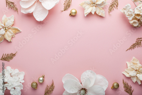 Christmas composition. Frame made of christmas decoration on pink background. Flat lay, top view. photo