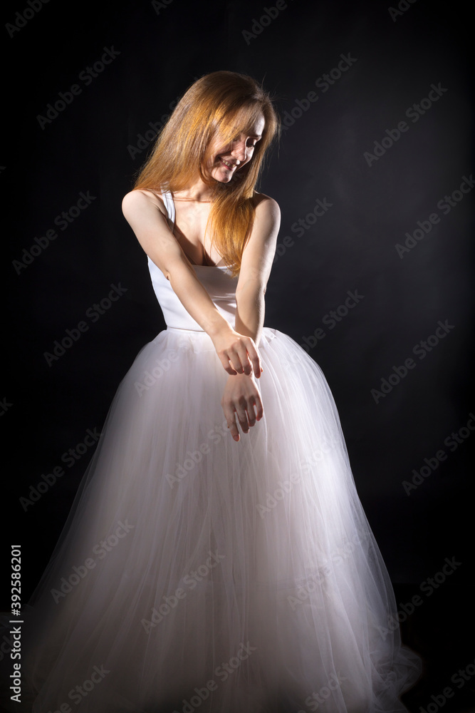 Fototapeta premium Young beautiful woman in a tutu studio portrait.