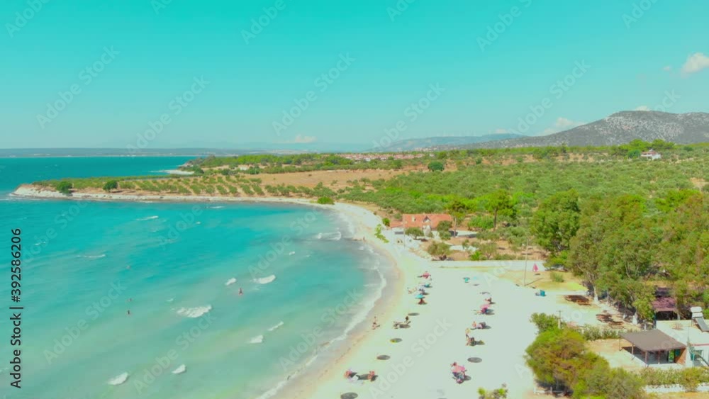Aerial view of white beach and turquoise water landscape on a windy summer day in Didim, Turkey. Colorful umbrellas at the white beach in Aegean coast of Turkey Aerial view of white beach and turquoise water landscape on a windy summer day in Didim, Turkey. Colorful umbrellas at the white beach in Aegean coast of Turkey