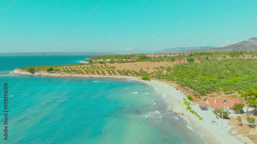 Aerial view of white beach and turquoise water landscape on a windy summer day in Didim, Turkey. Colorful umbrellas at the white beach in Aegean coast of Turkey Aerial view of white beach and turquoise water landscape on a windy summer day in Didim, Turkey. Colorful umbrellas at the white beach in Aegean coast of Turkey