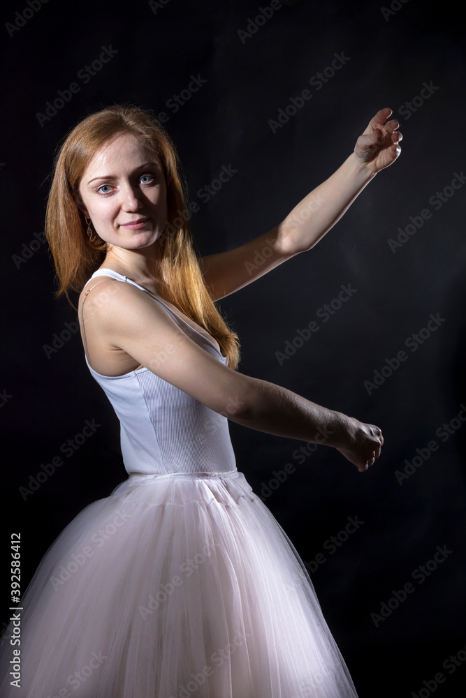 Fototapeta premium Young beautiful woman in a tutu studio portrait.