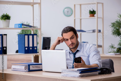 Young male bookkeeper working in the office