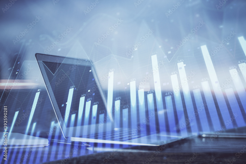 Naklejka premium Stock market chart hologram drawn on personal computer background. Double exposure. Concept of investment.