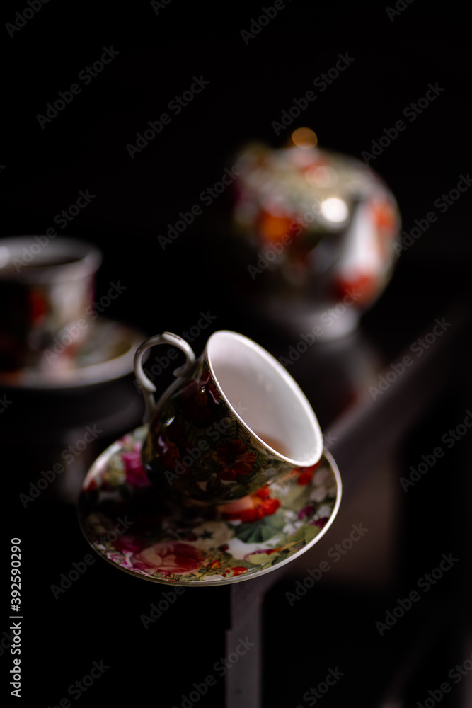 a cup of tea falling from the table a cup of tea falling from the table