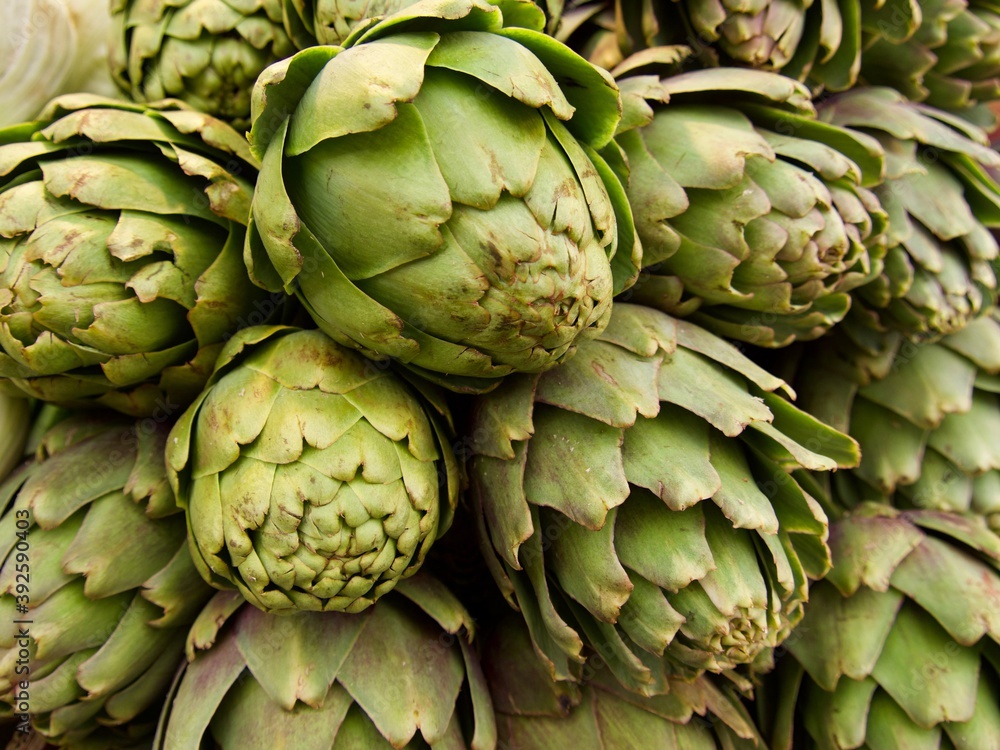 Fresh artichokes at green grocery on Mediterranean street market, southern Europe Fresh artichokes at green grocery on Mediterranean street market, southern Europe
