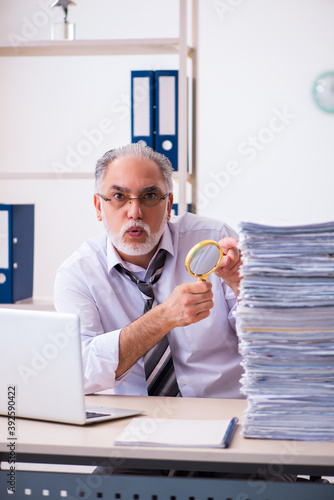 Old male employee unhappy with excessive work in the office