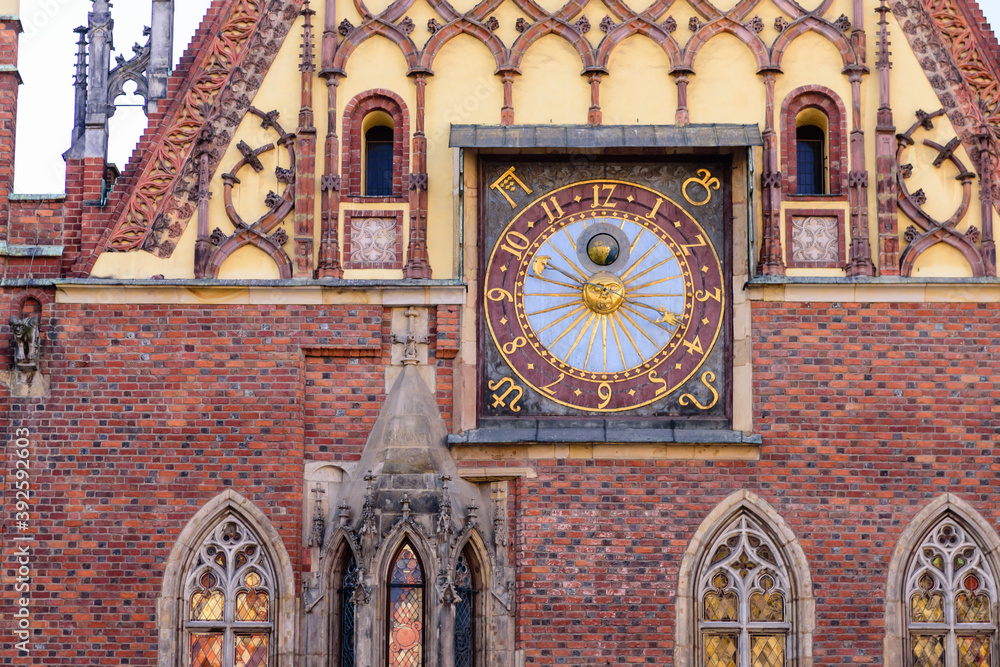 Sightseeing of Wroclaw, Poland. City hall of Wroclaw - the monument of architecture in the Gothic style. Detail of the facade with an astonomical clock.