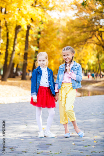 Portrait of two little girls in autumn park