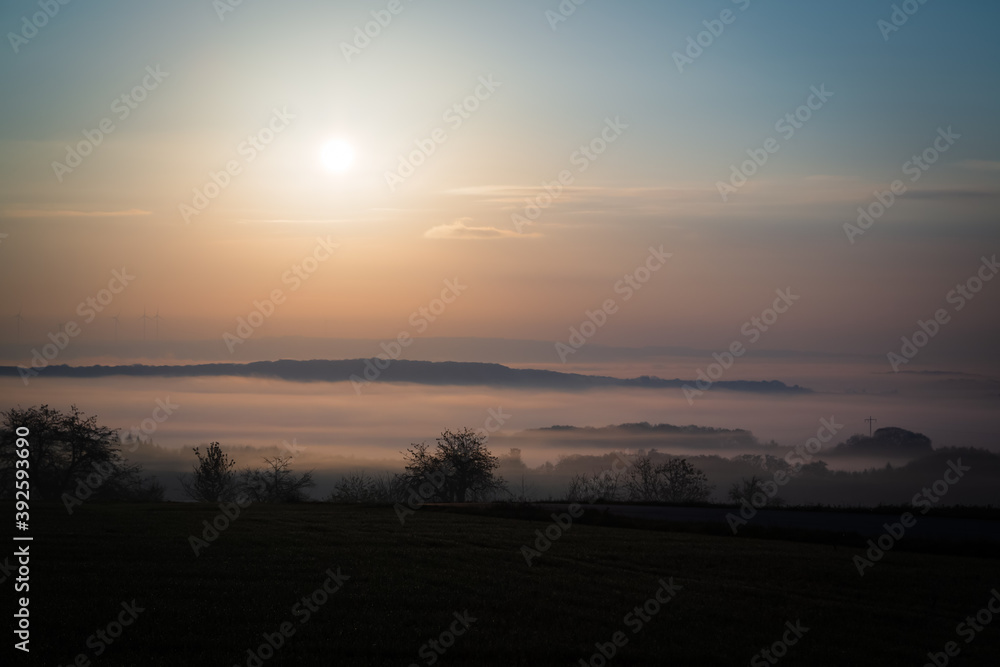 Sunrise over valley with fog in Luxembourg