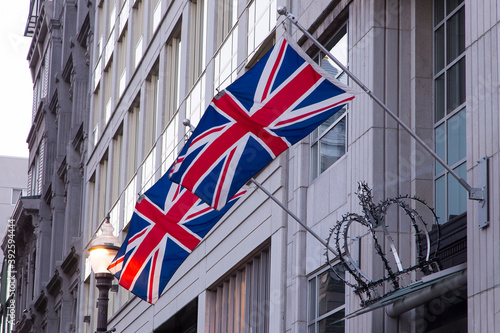 A giant metallic crown and two Union Jack flags displayed over the entrance of a St. Joseph Street building in the St. Roch neighbourhood, Quebec City, Quebec, Canada