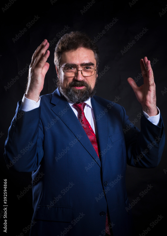 Mature businessman dressed in blue suit with red tie studio portrait. Mature businessman dressed in blue suit with red tie studio portrait.