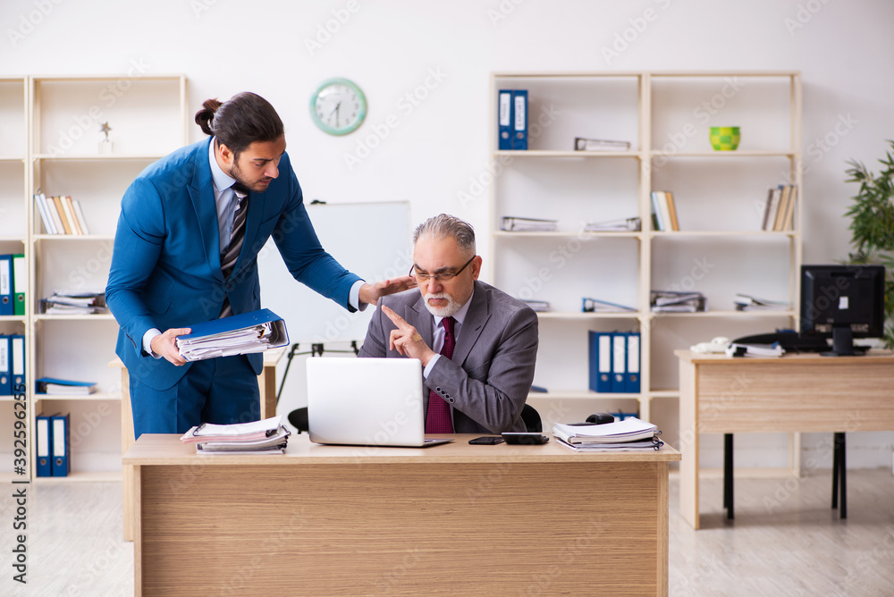 Two male colleagues working in the office Two male colleagues working in the office