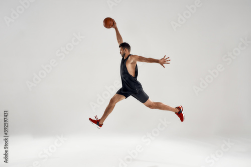 Young caucasian basketball player leading ball