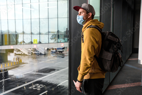 A guy wearing medical mask in an airport