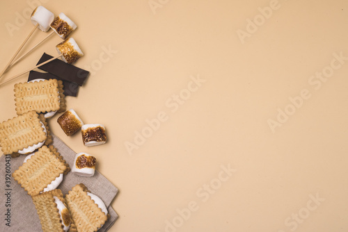 Freshly Toasted Smores with Marshmallow and Chocolate on Yellow Background Top View Copy Space Horizontal